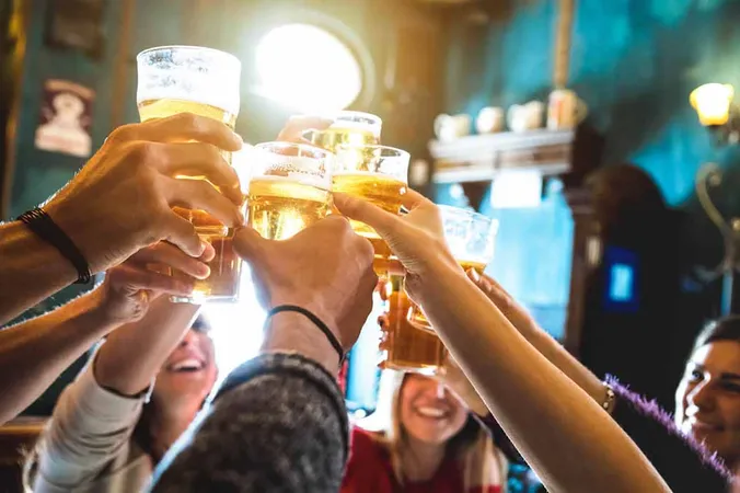 Guests raising beers at a café table.